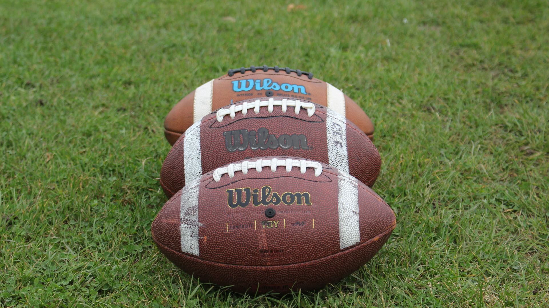 a football laying on top of a lush green field