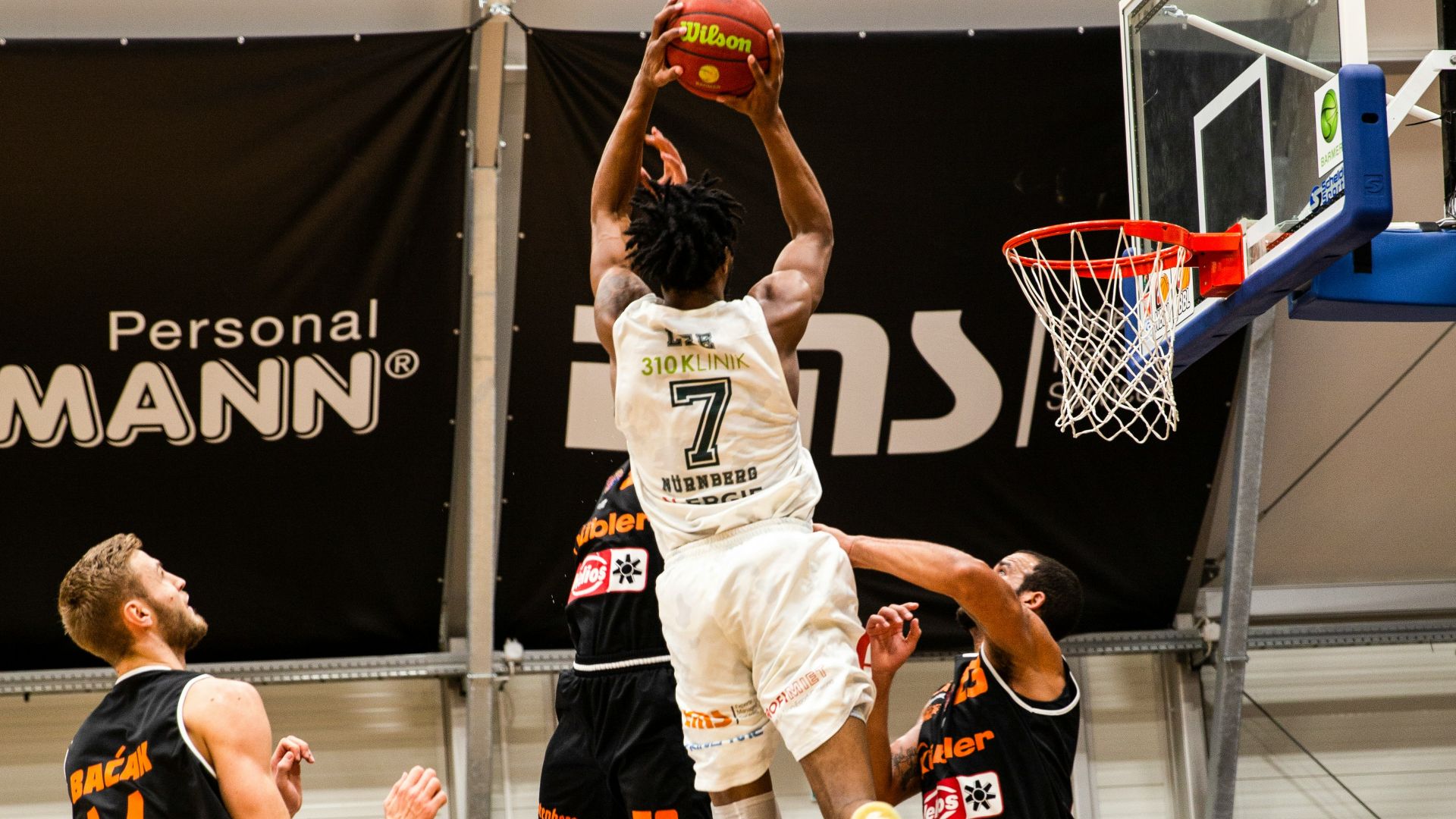people playing basketball inside court