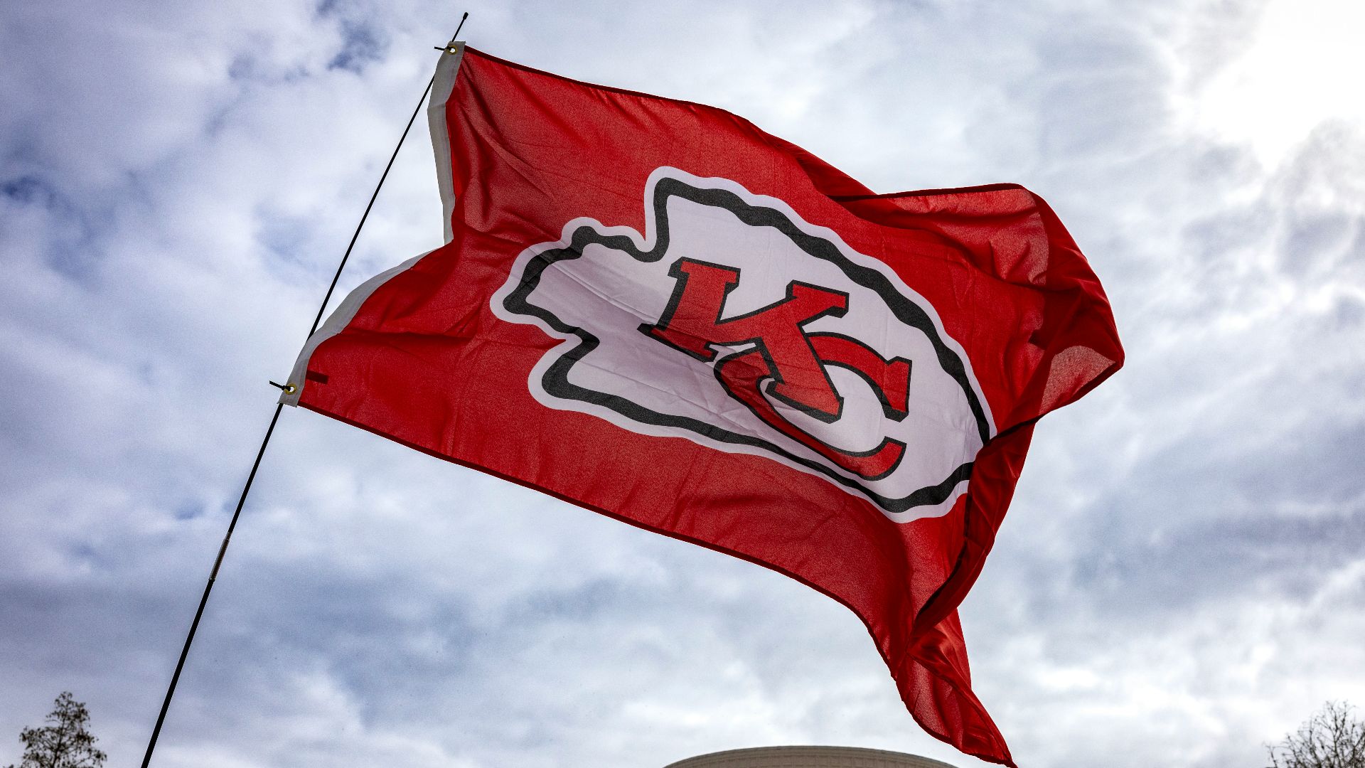a kansas chiefs flag flying in front of a building