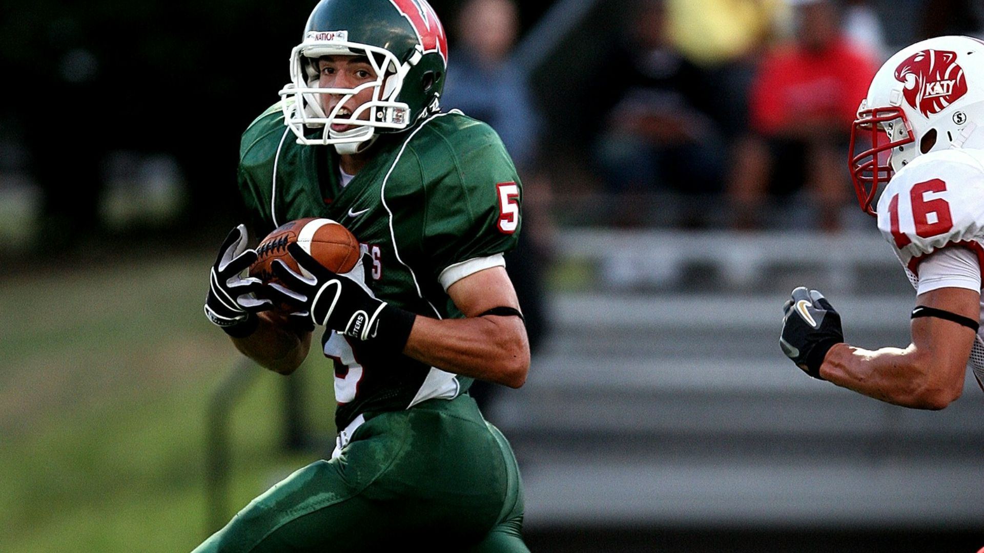 man in green 5 American football jersey holding ball