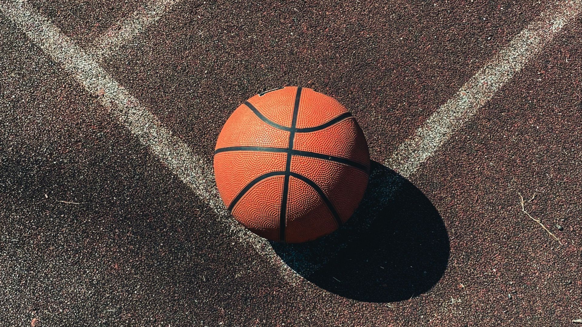 brown basketball on gray concrete floor