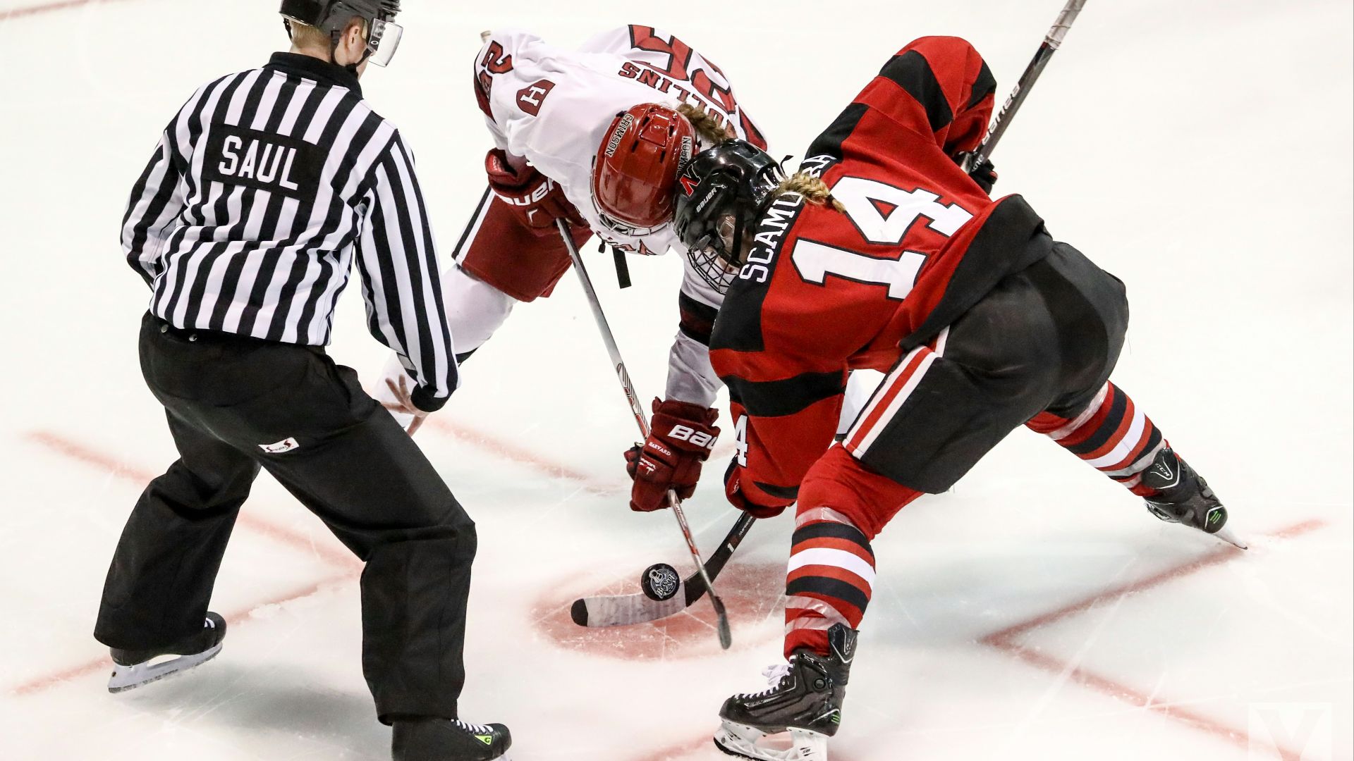 two persons playing ice hockey with referee