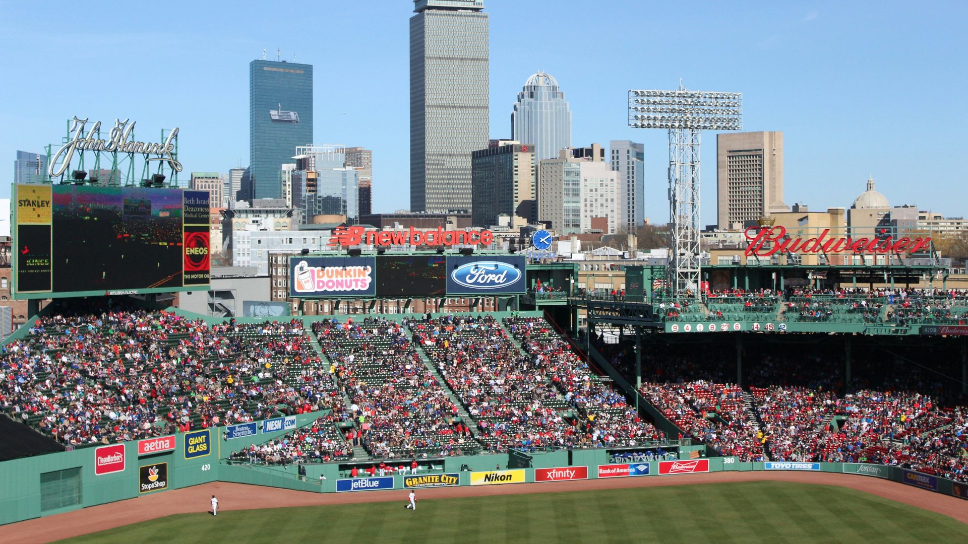 people watching baseball game during daytime