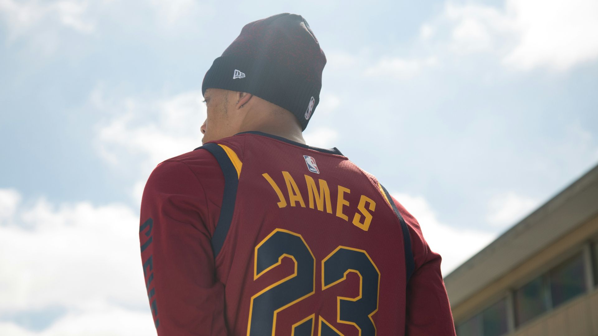 man in black and red long sleeve shirt wearing black cap