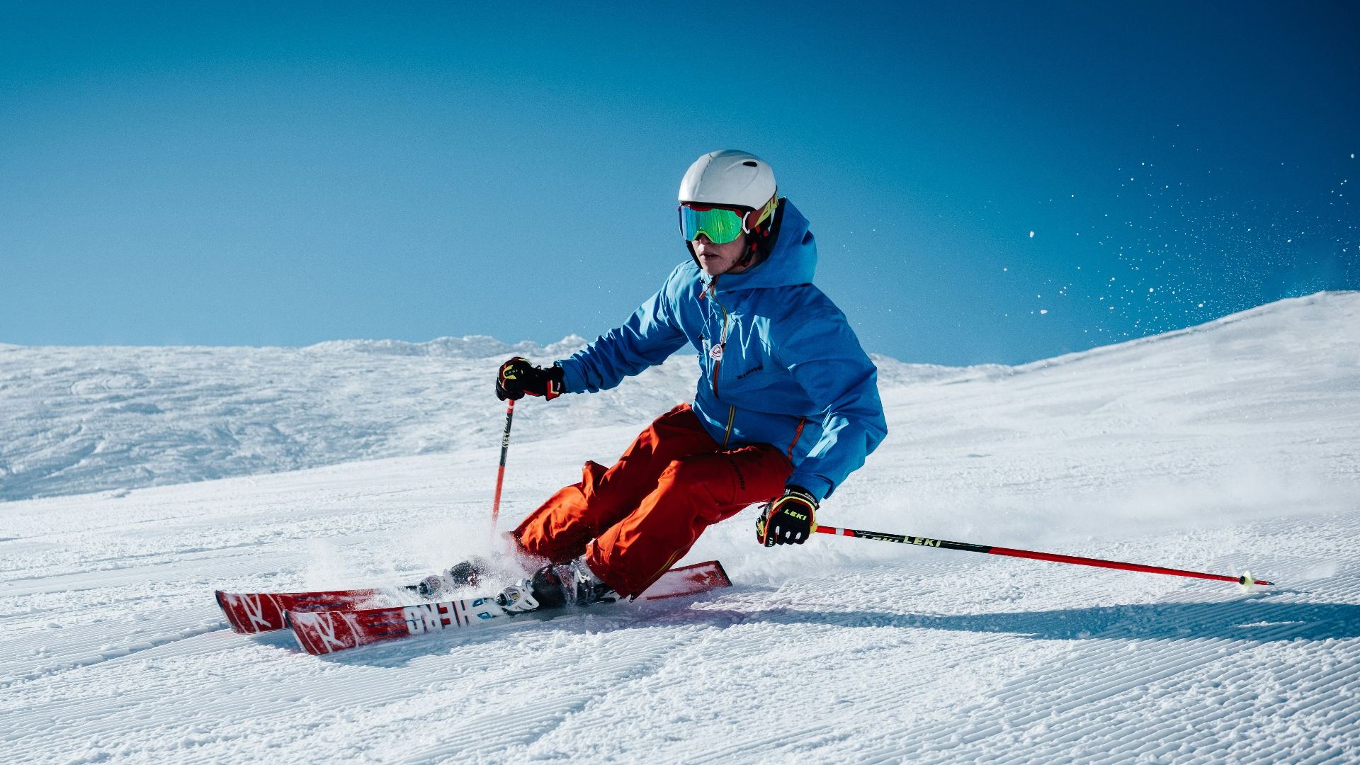 man ice skiing on hill