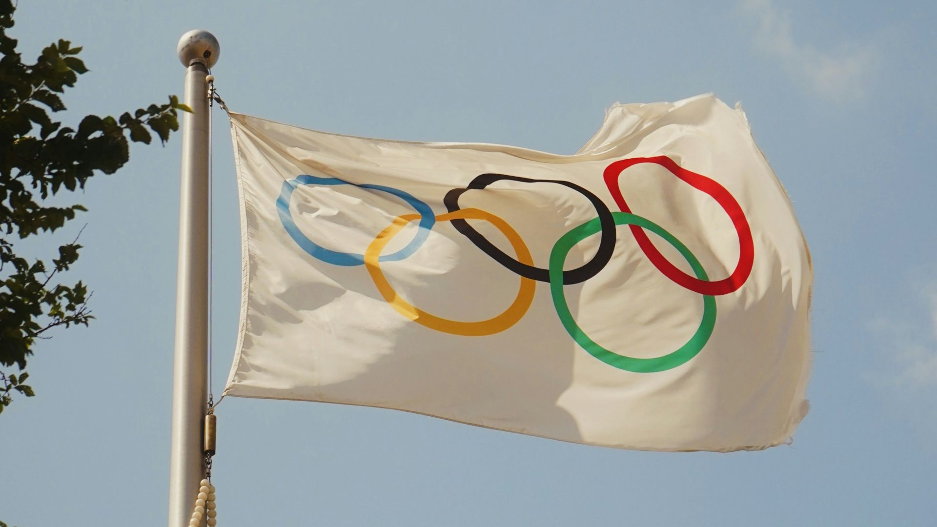 A white flag with the olympic rings on it
