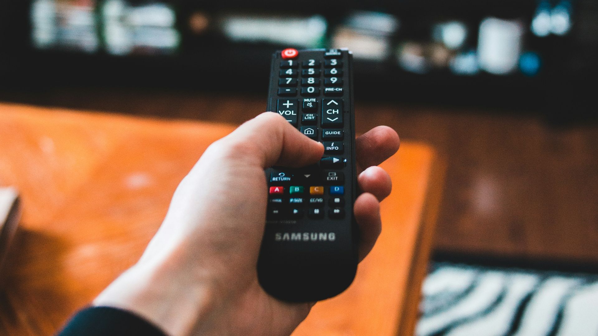 person holding black remote control