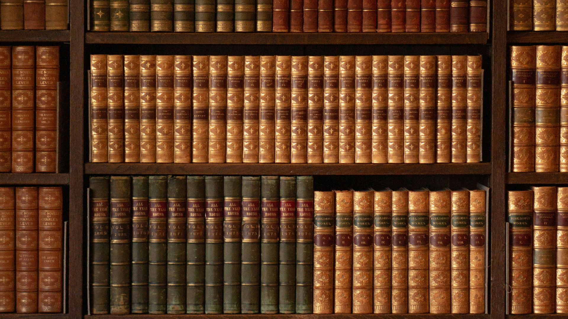 brown wooden book shelf with books