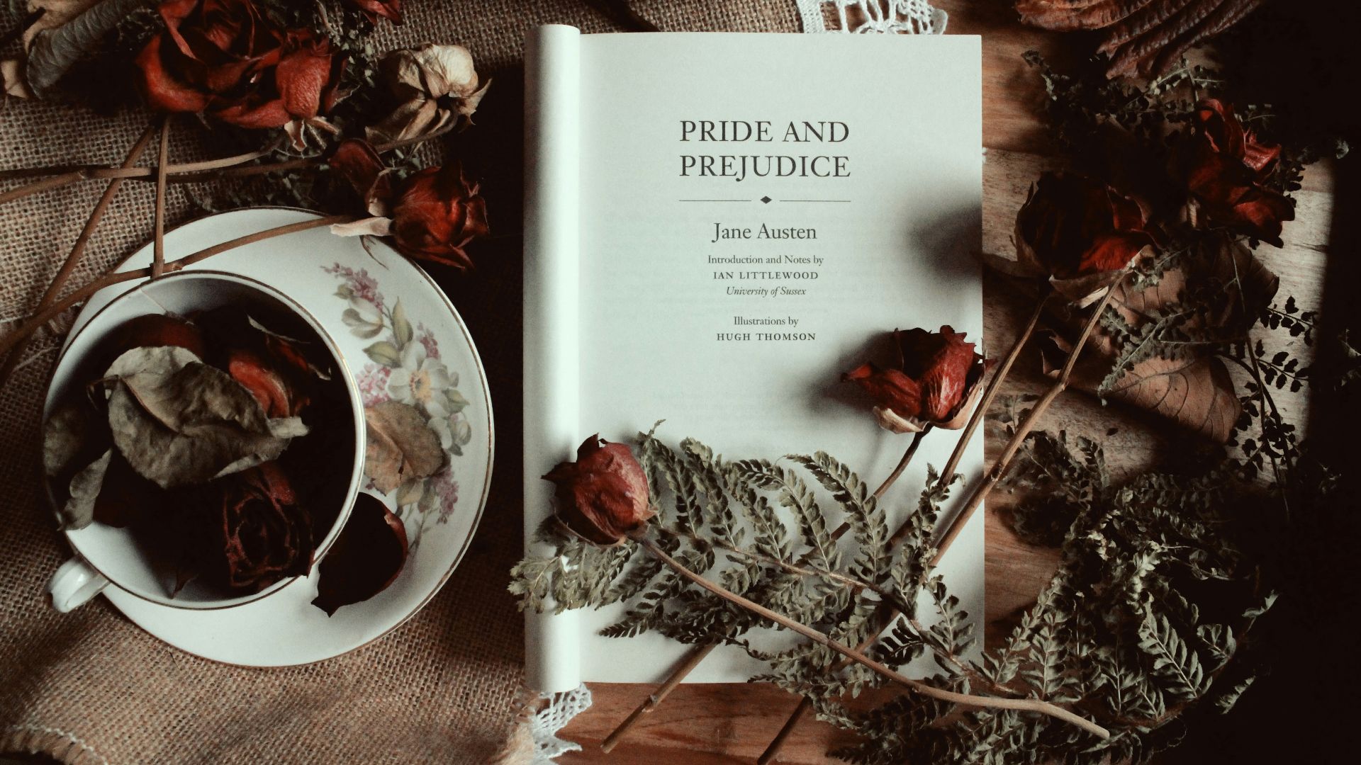 a book sitting on top of a table next to a cup of tea