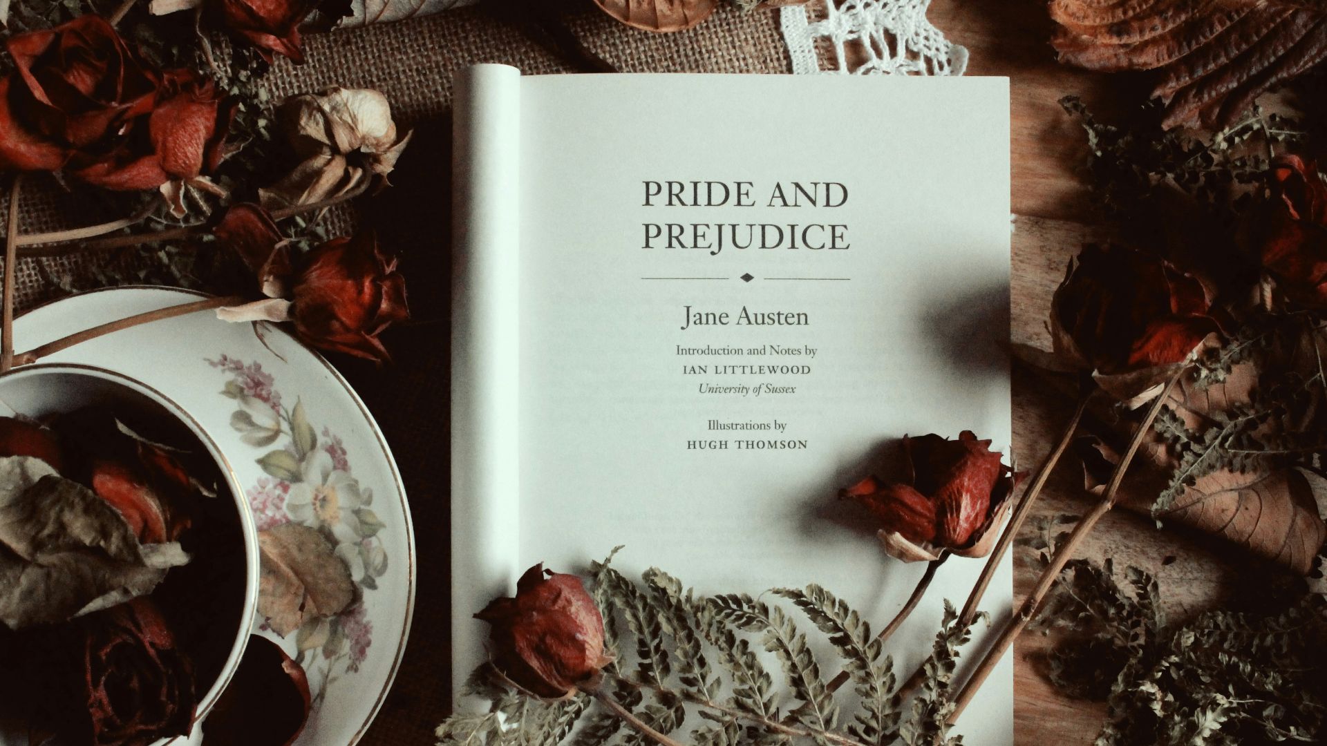 a book sitting on top of a table next to a cup of tea