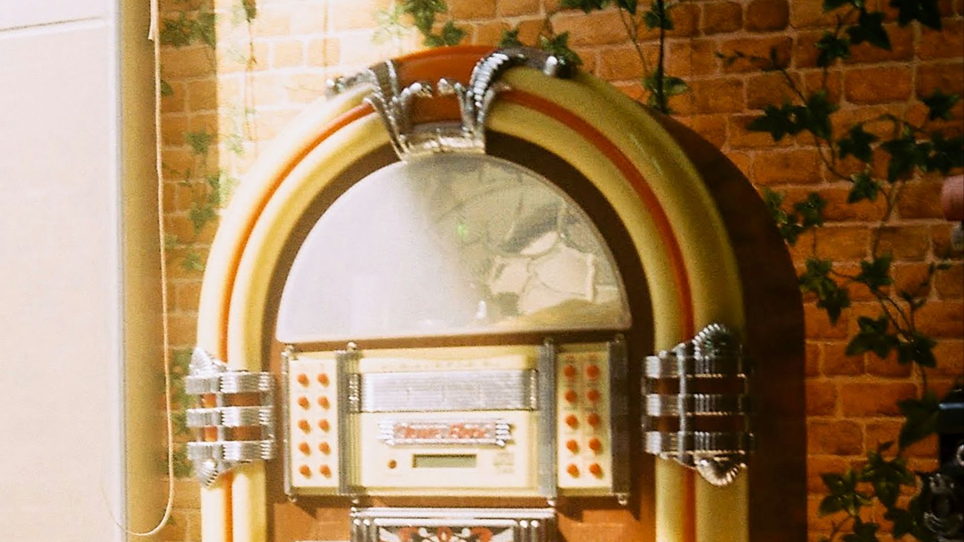 brass and red telephone booth