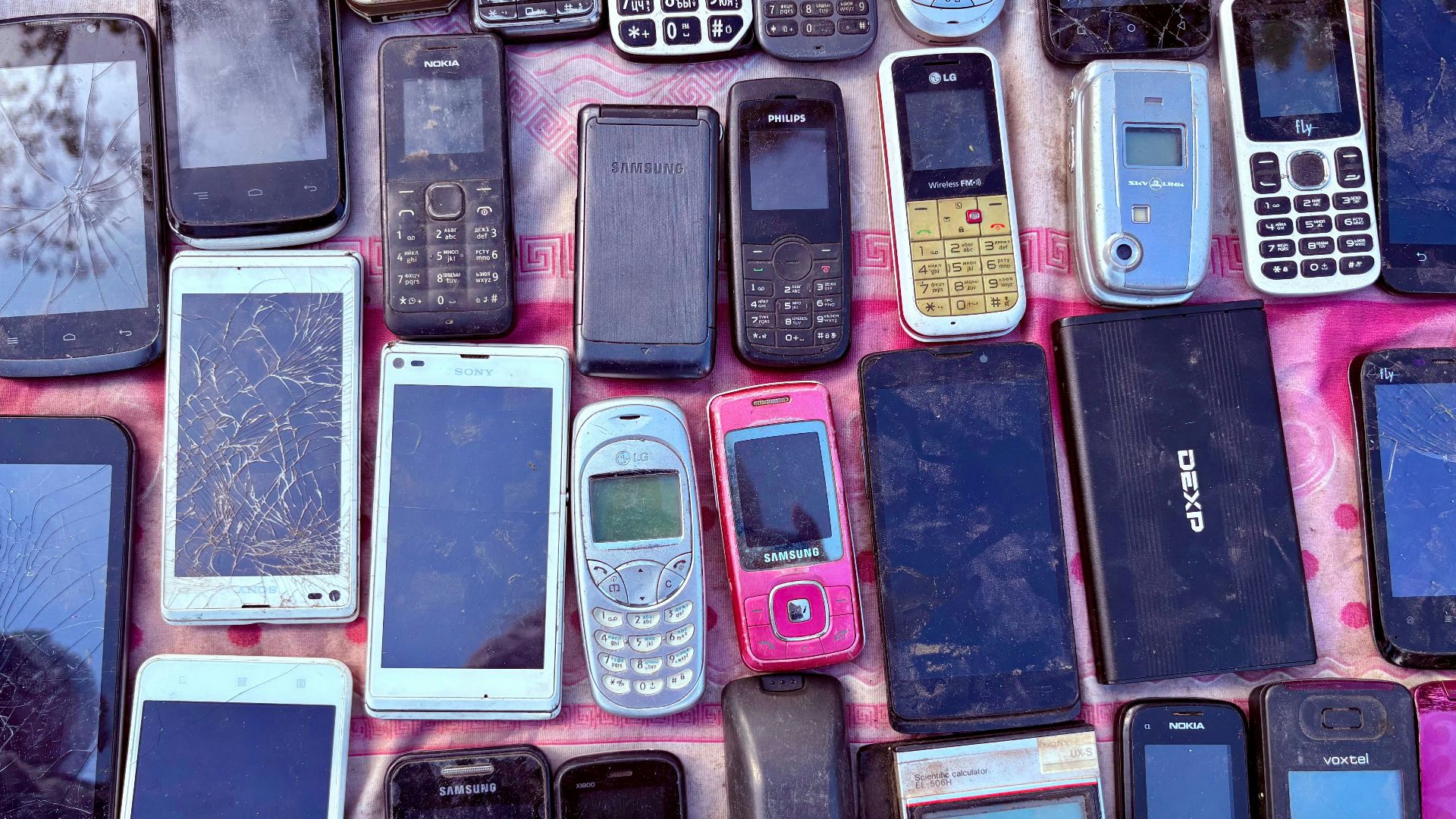 A collection of various old mobile phones and devices.
