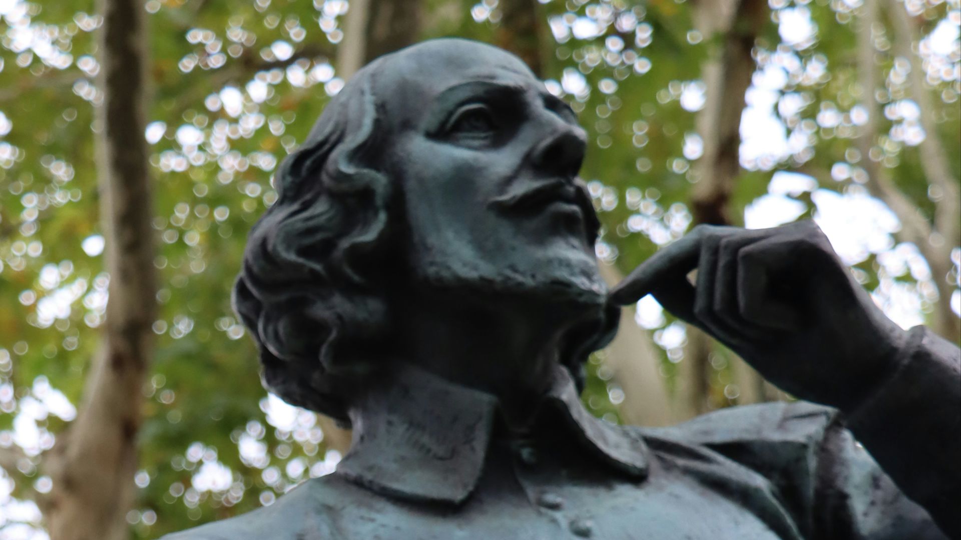 a statue of a man with a leaf in his hand