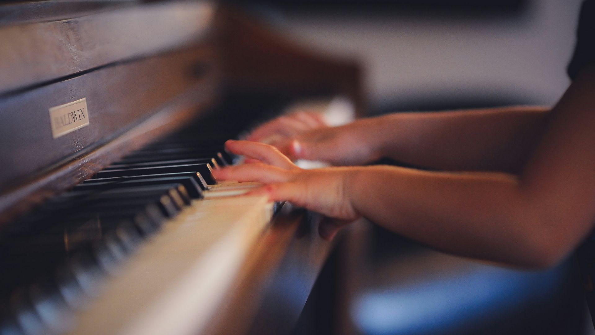 person playing upright piano