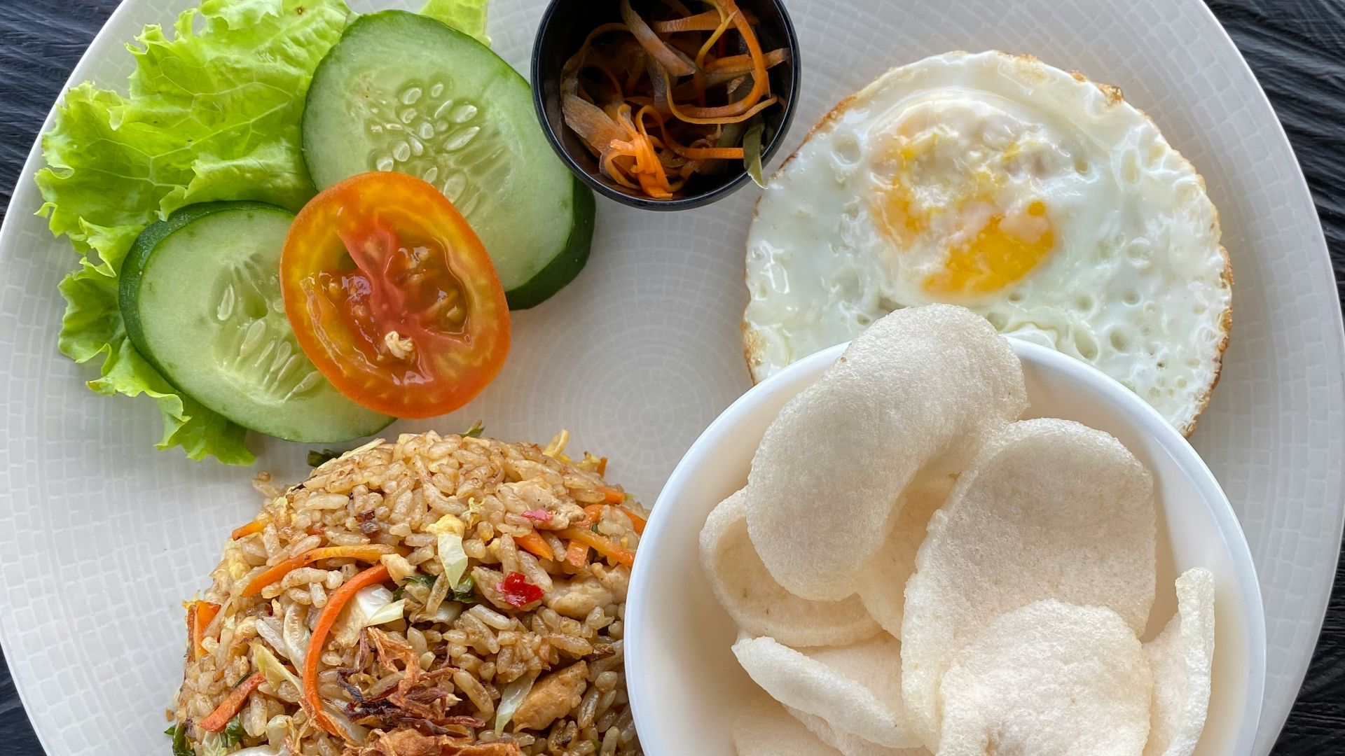 a white plate topped with rice and vegetables