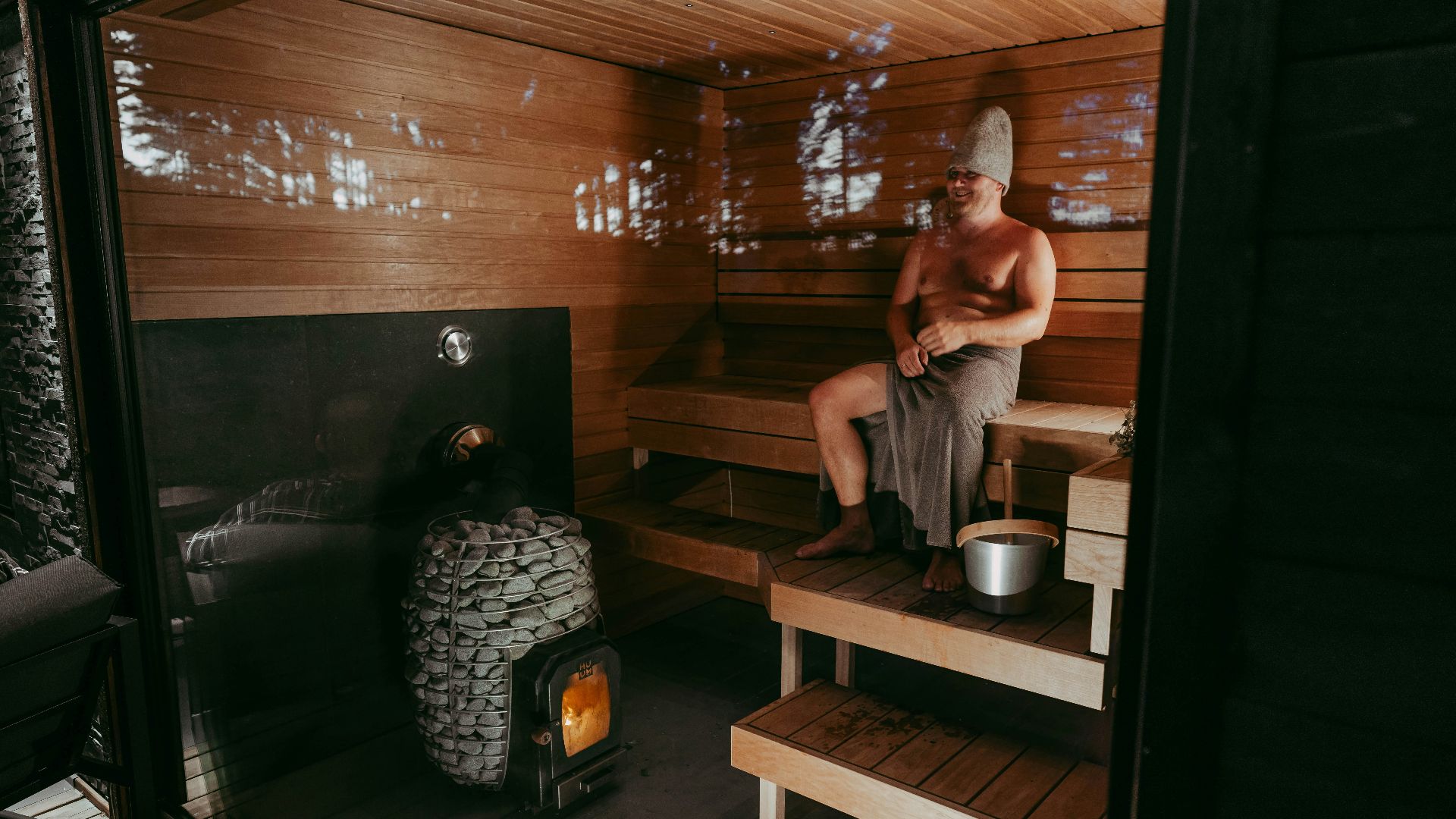 a man sitting in a wooden sauna