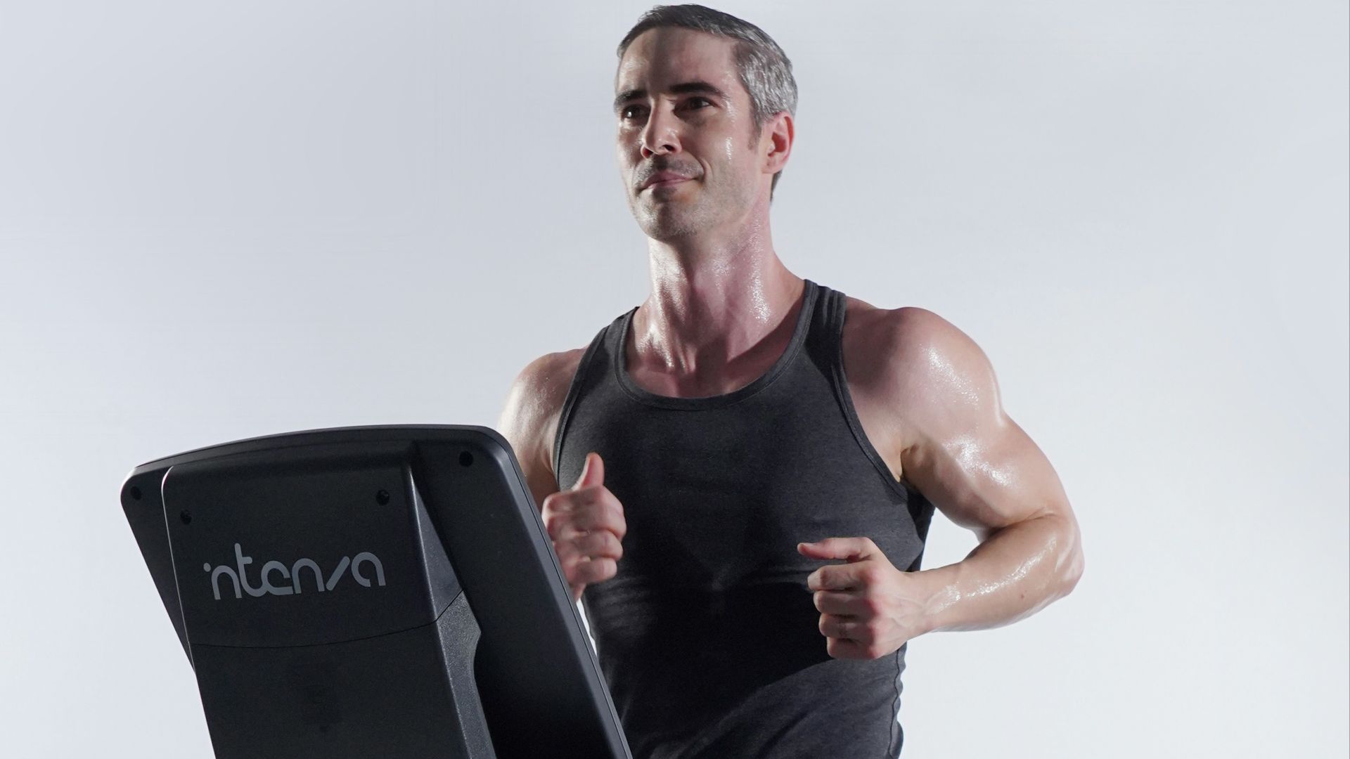 a man on a treadmill with a laptop