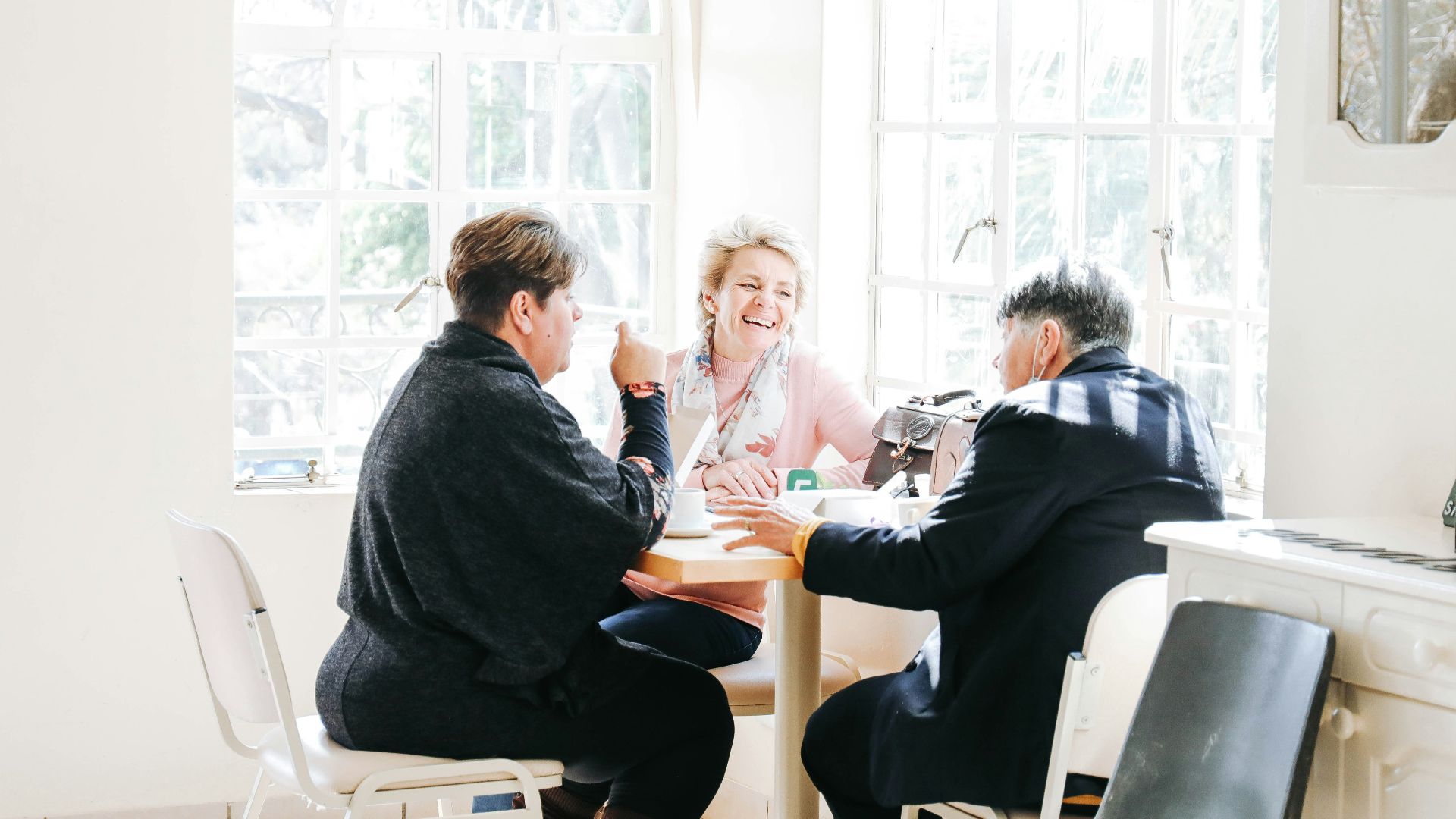 a group of people sitting around a table