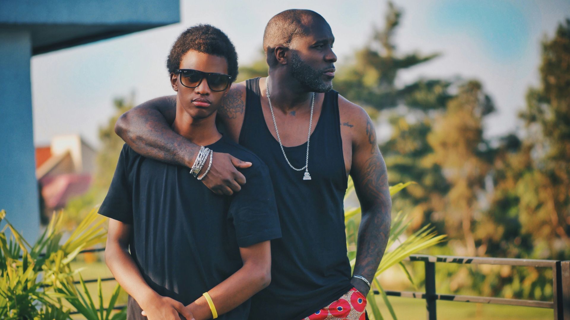 two men same standing near green leaf plant