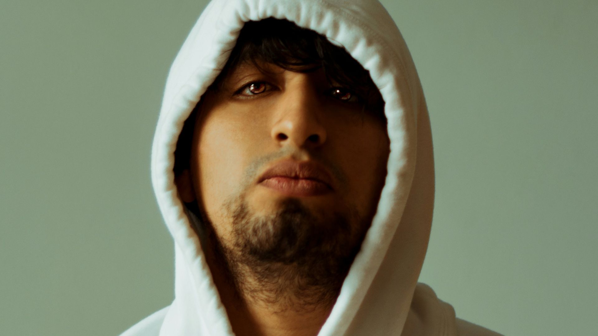 man in white hoodie taking selfie