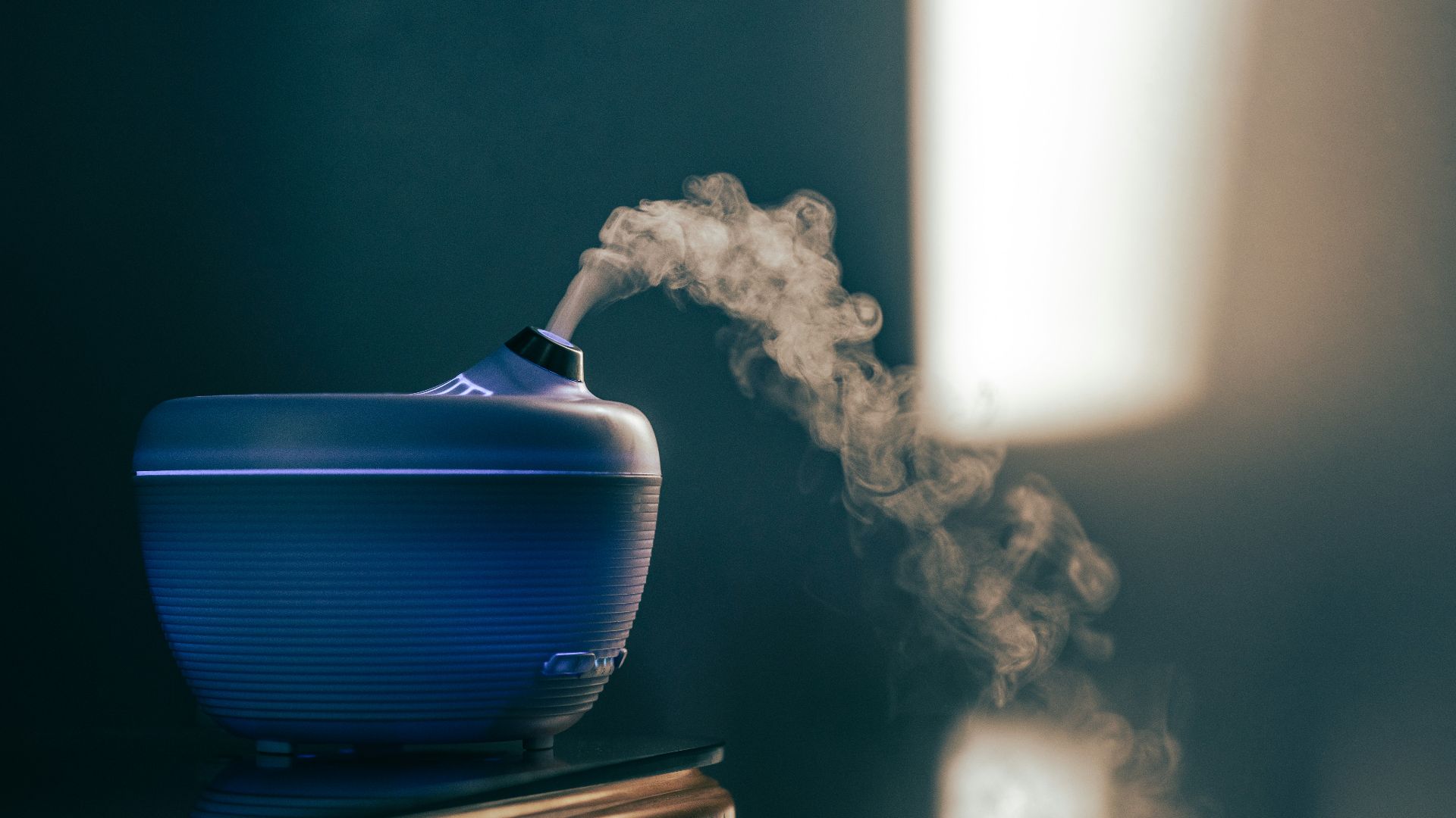 blue and white ceramic container on brown wooden table