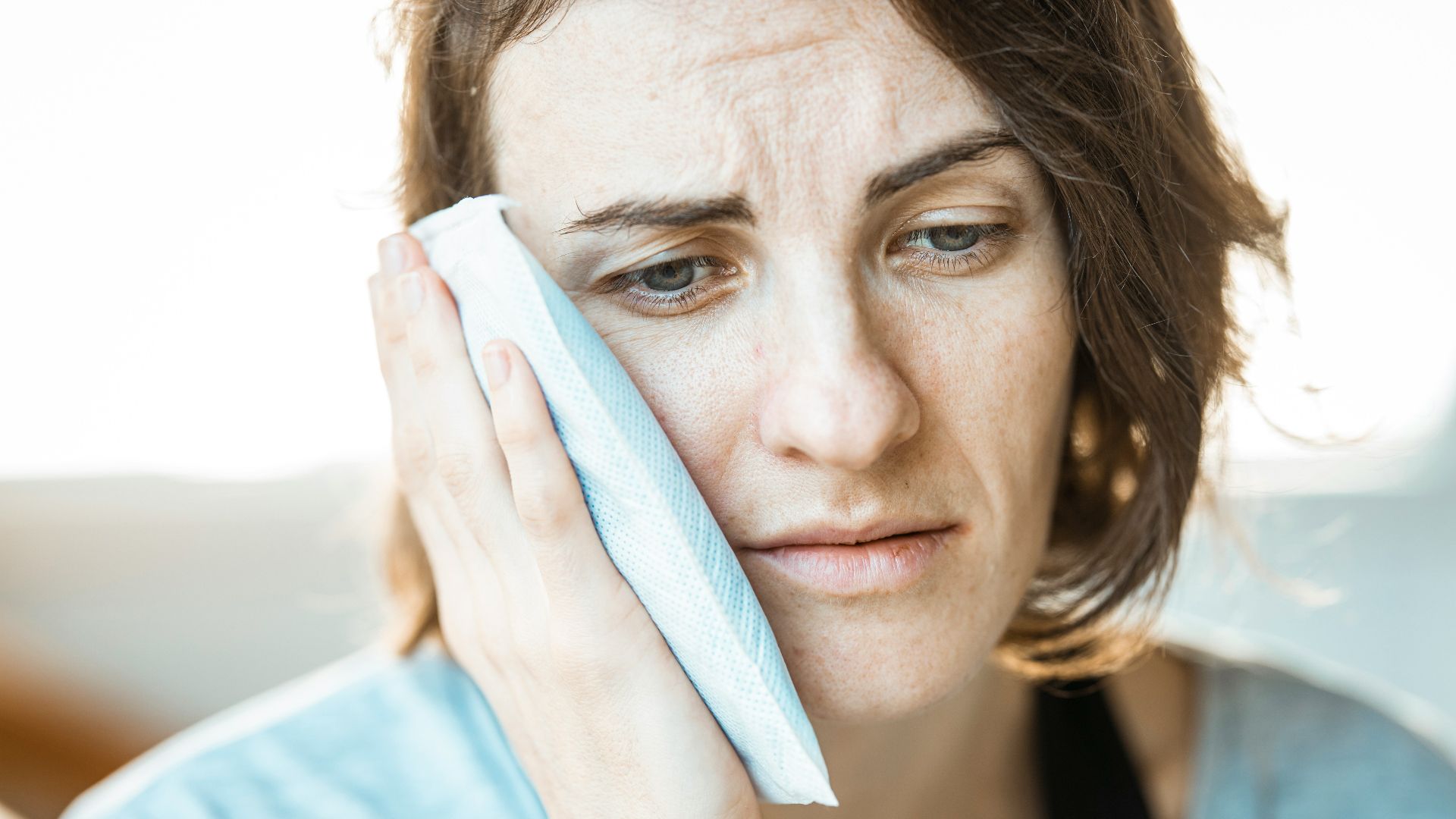 woman in black tank top holding white textile