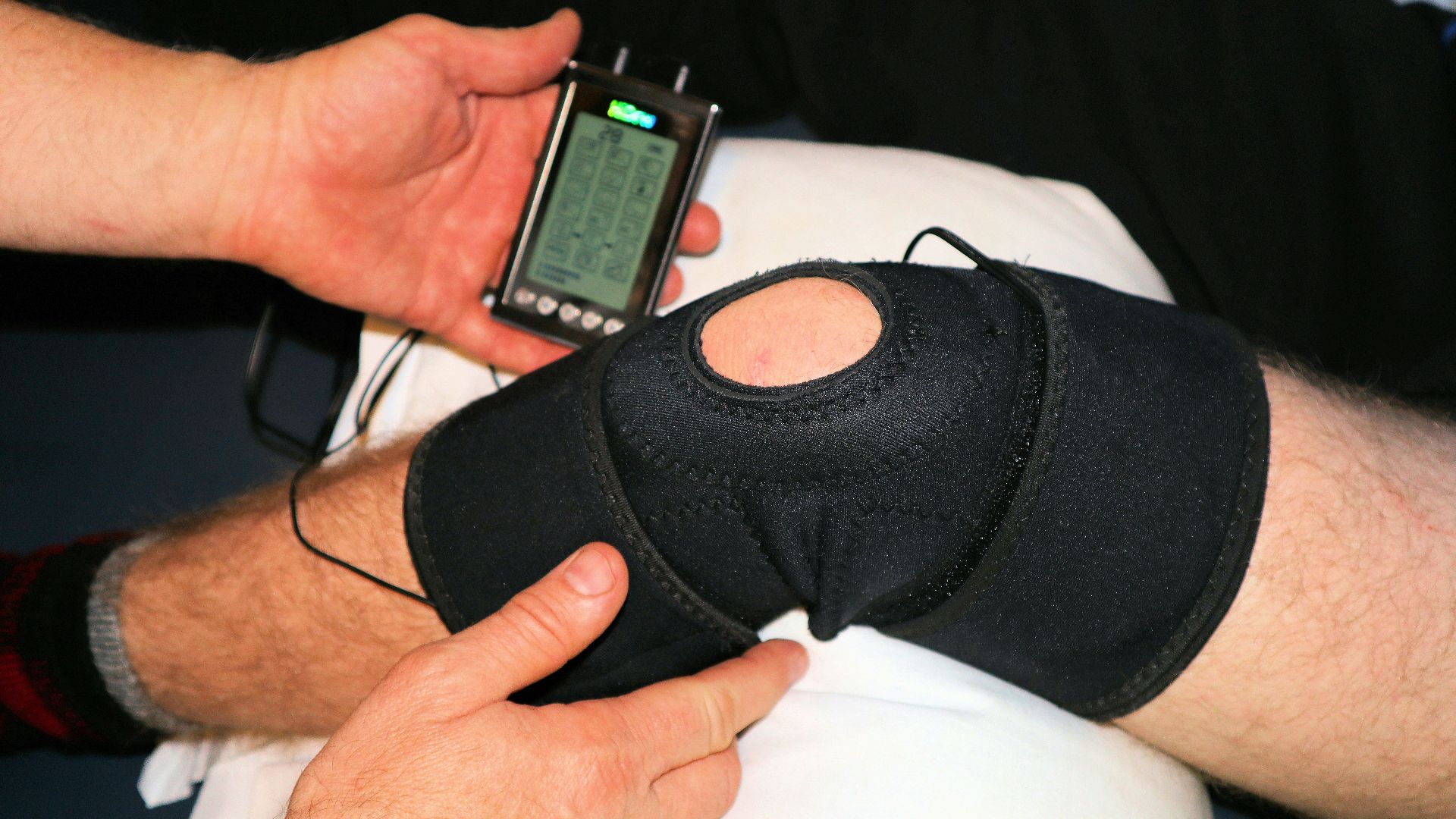 person holding black knit cap