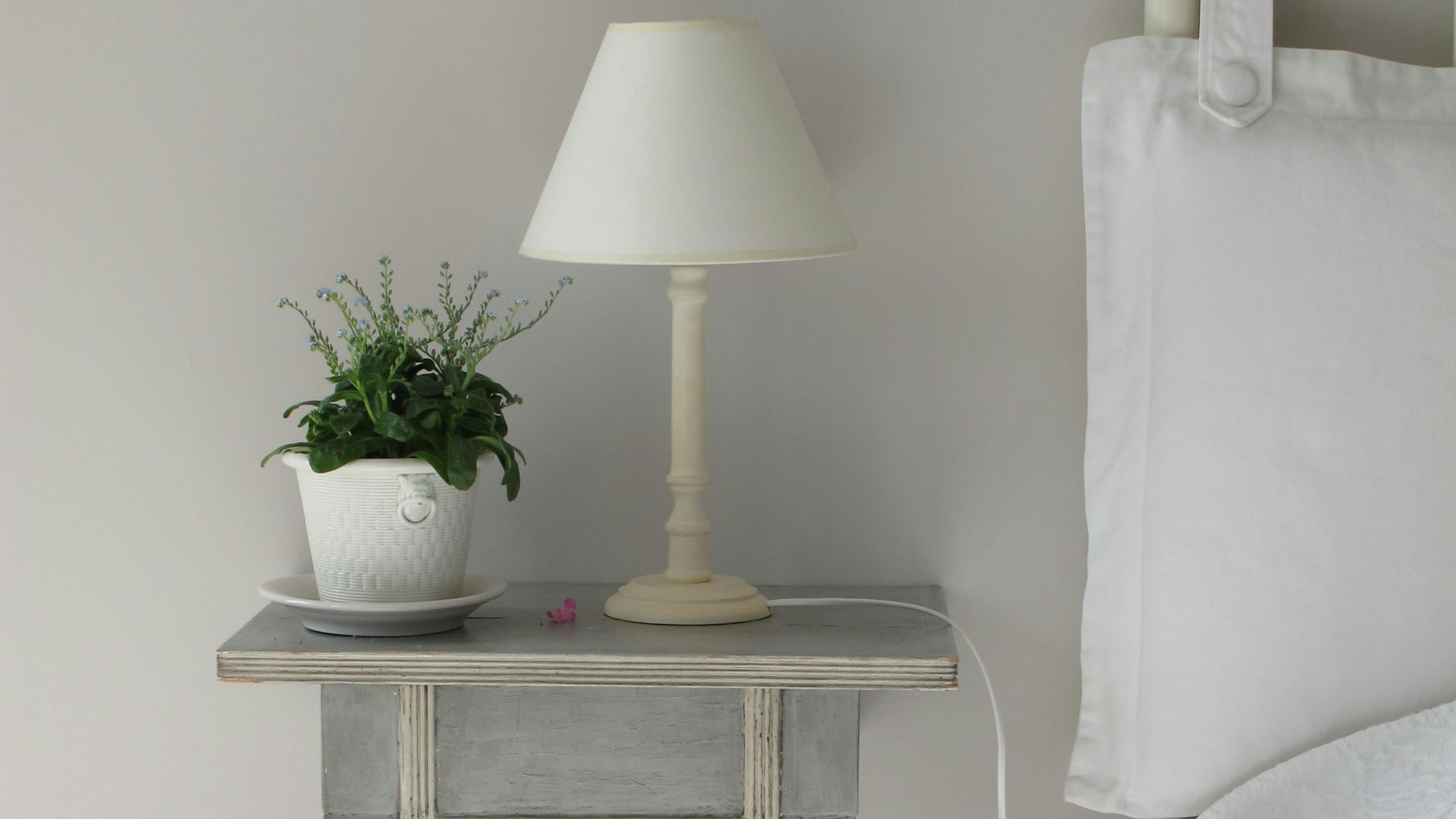 white table lamp on gray end table