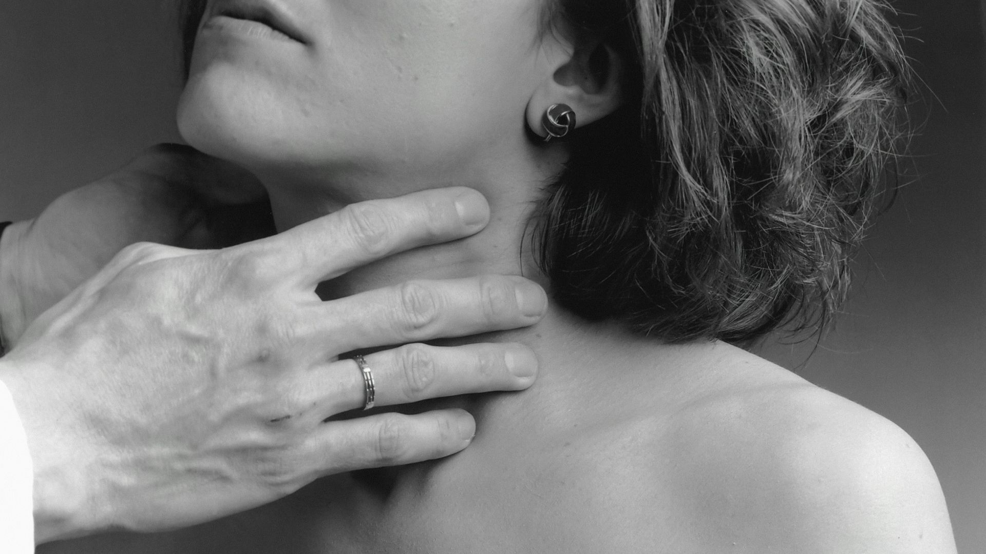 a woman has her hand on the shoulder of a man