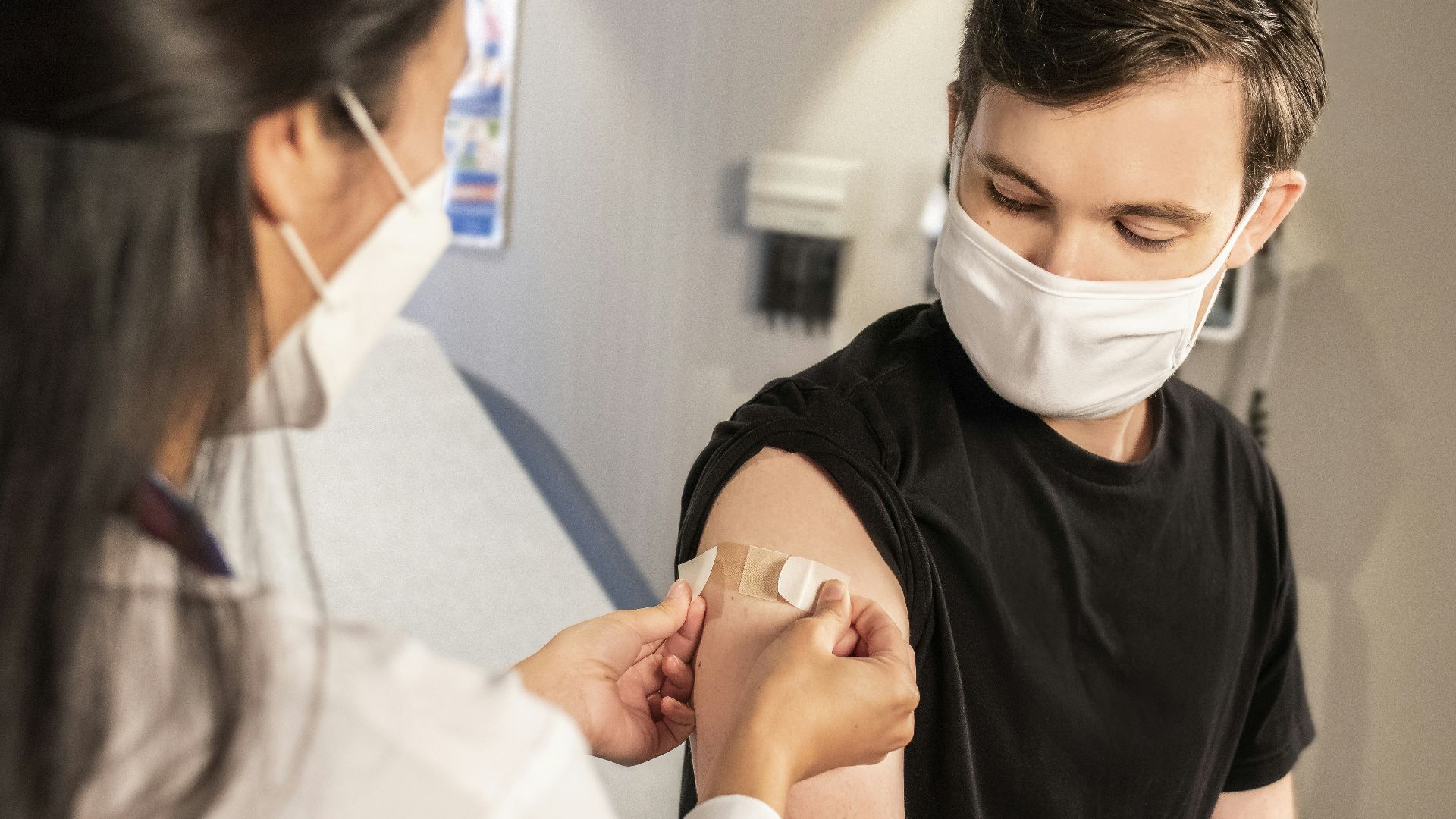 woman in black crew neck t-shirt wearing white face mask