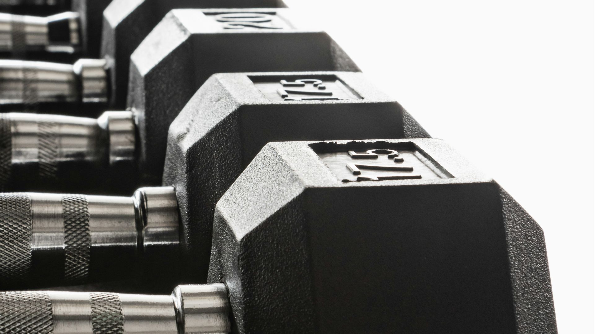 black and silver dumbbells on white background