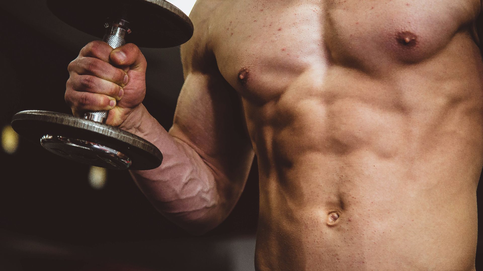 man holding black dumbbell