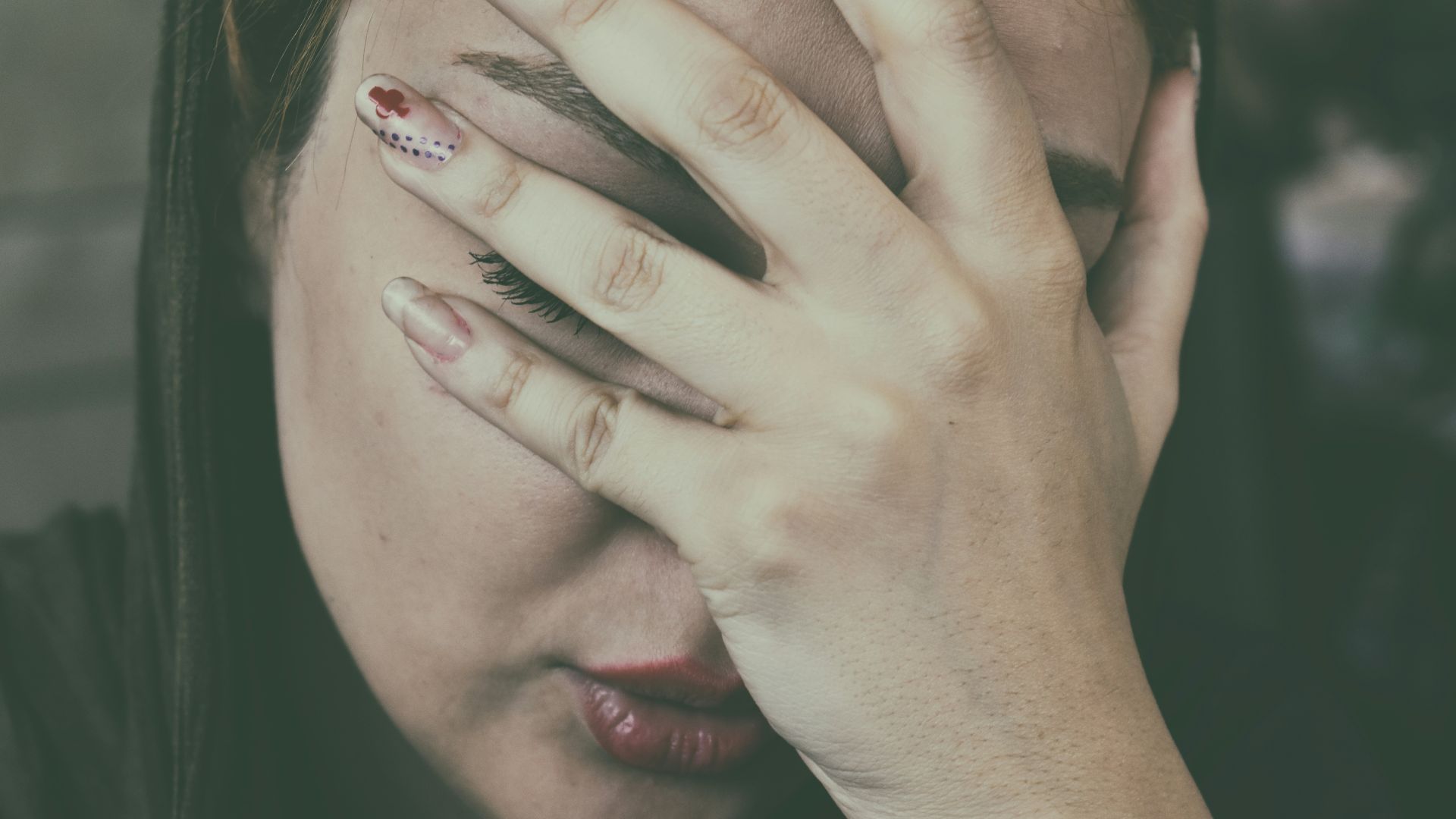 woman's hand on face