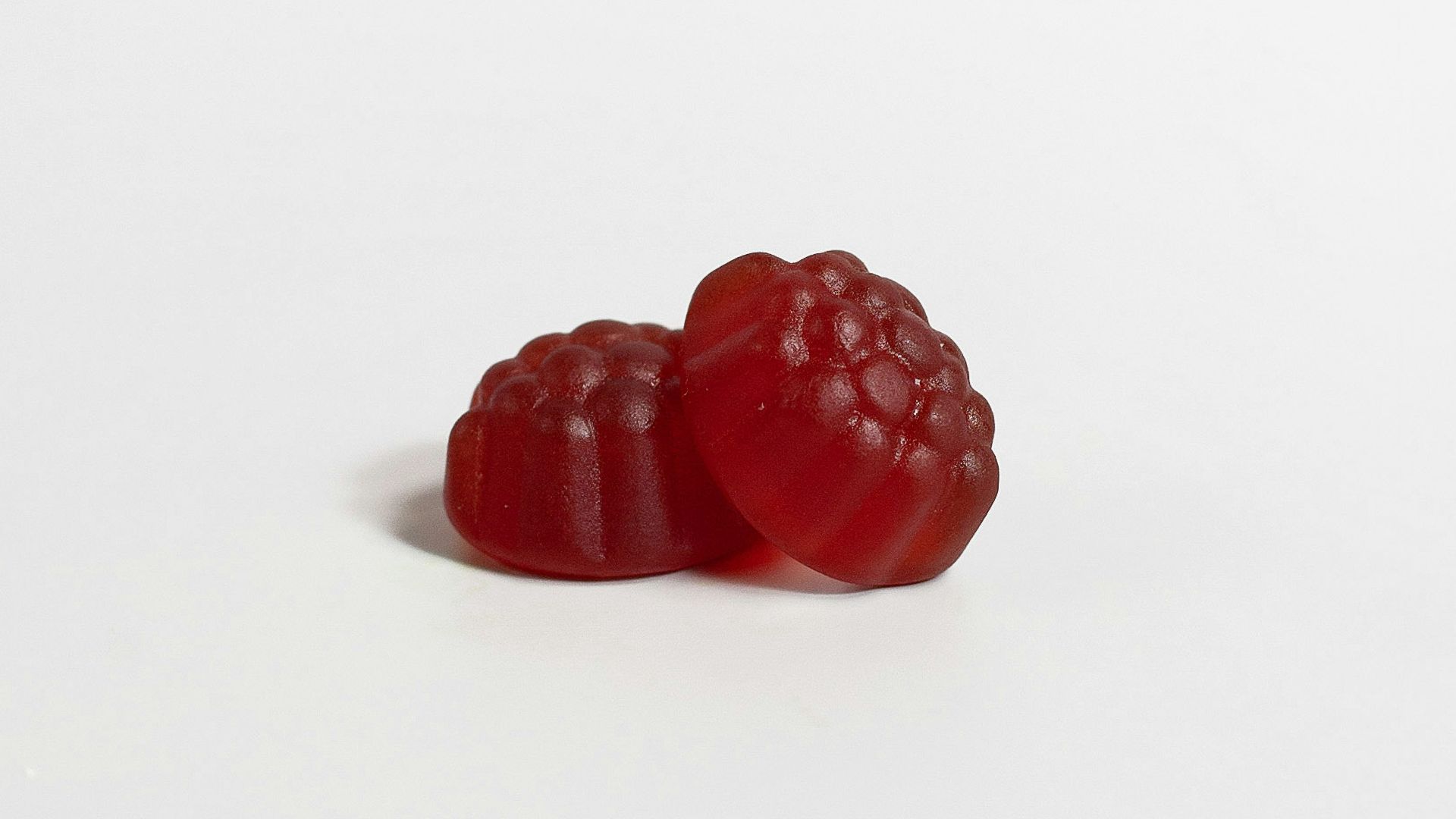 a red raspberry on a white background