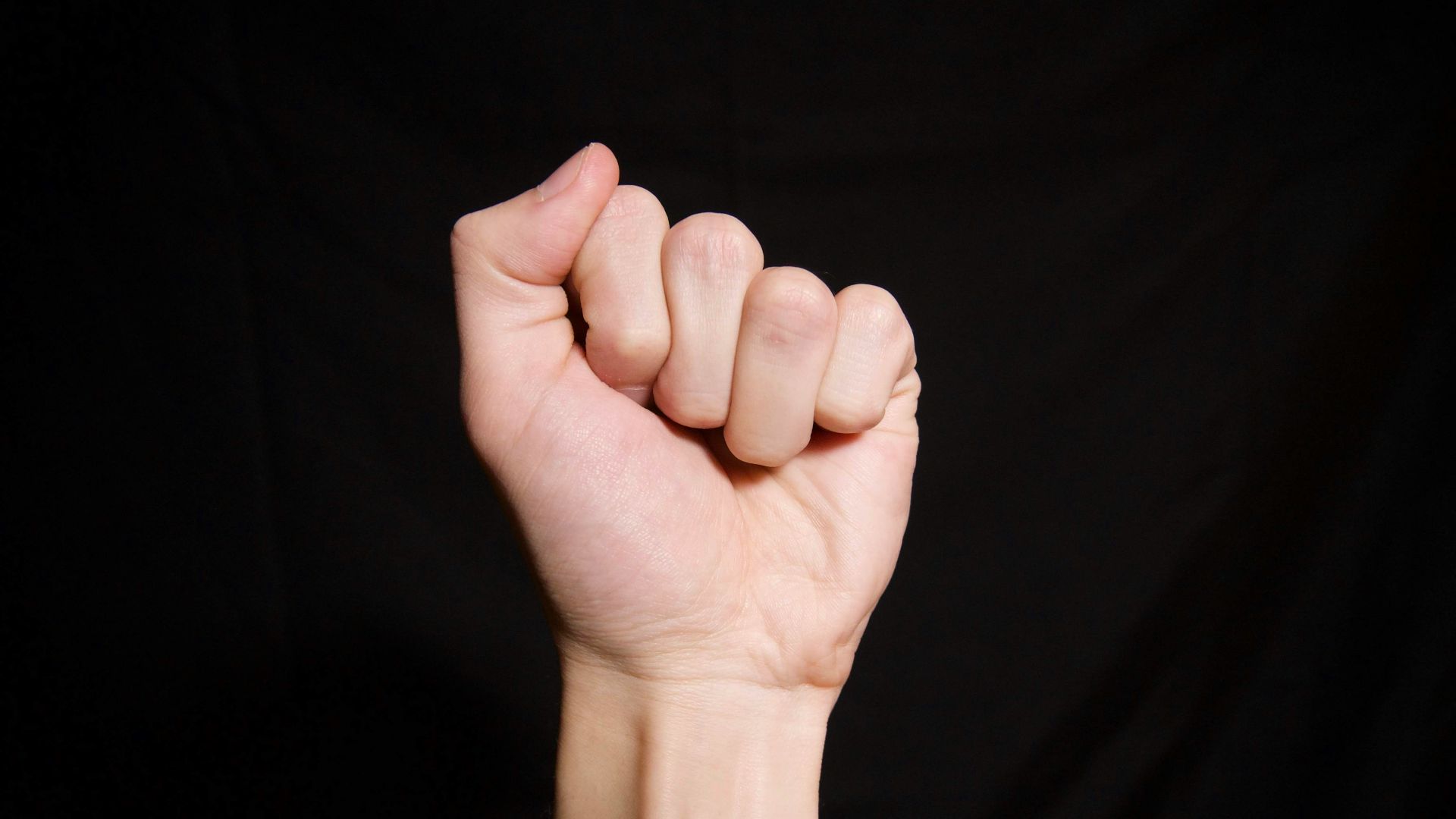 persons left hand on black textile