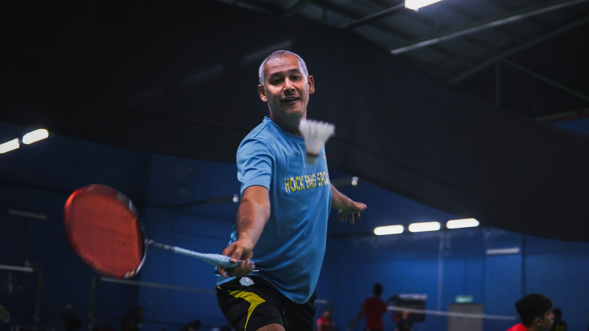 man in blue crew neck t-shirt and black shorts holding red basketball