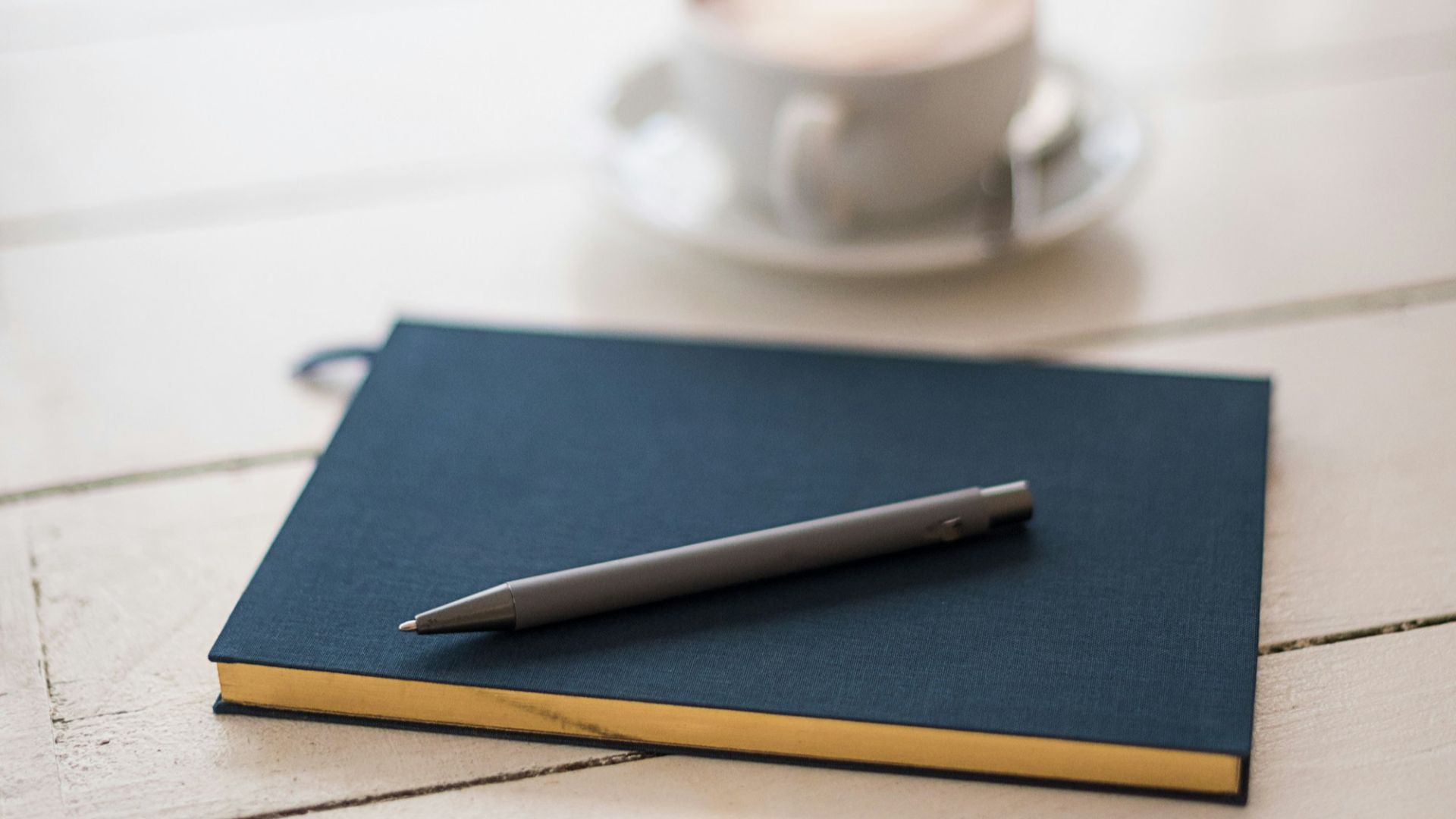 selective focus photography of black pen on book