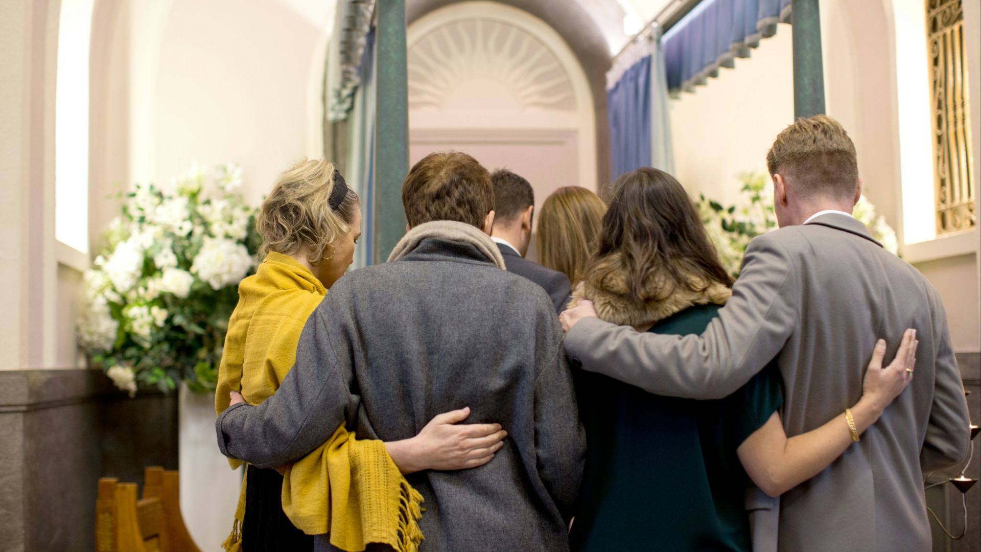 a group of people standing in front of a doorway
