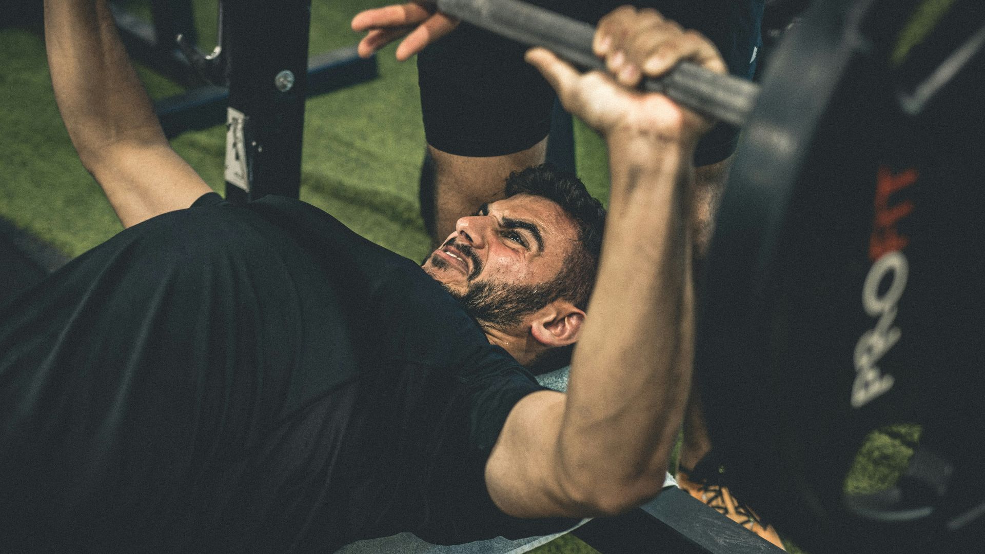 a man doing a bench press with a barbell