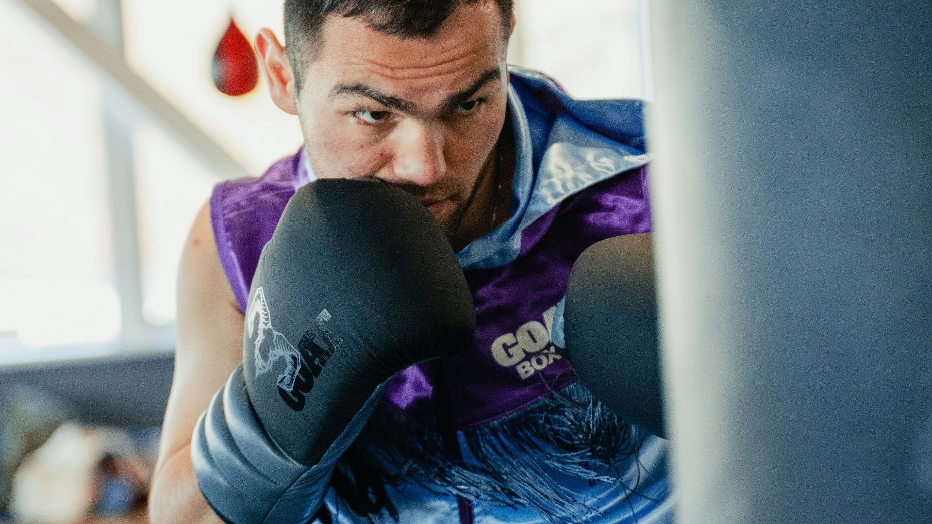 A man in a boxing ring with a punching glove