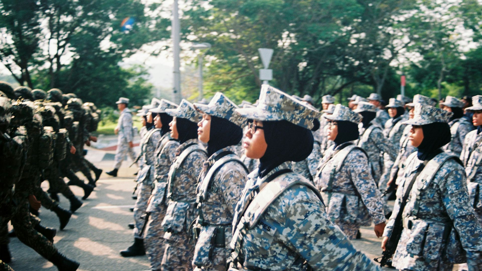 soldiers in black and white uniform standing on gray concrete road during daytime