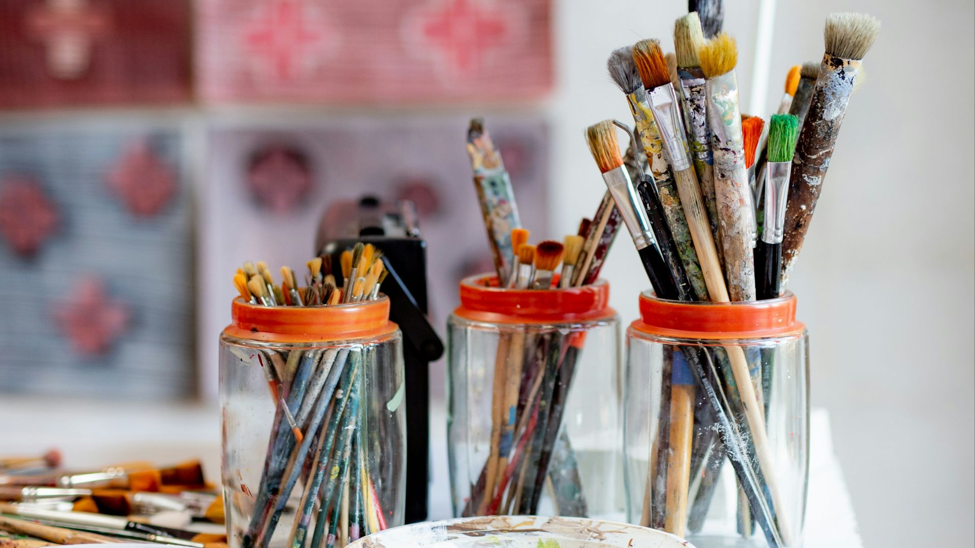 white ceramic plate with paint brushes and paint brushes