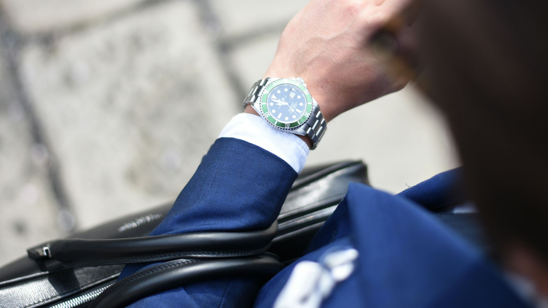 person looking at silver-colored analog watch
