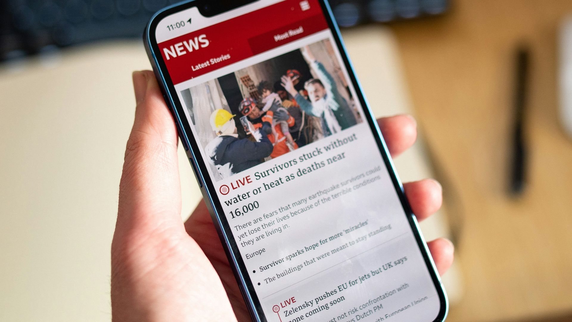 a person holding a cell phone in their hand