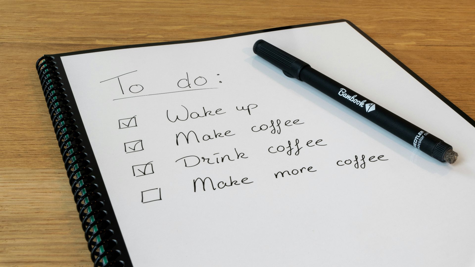 a notepad with a pen on top of it