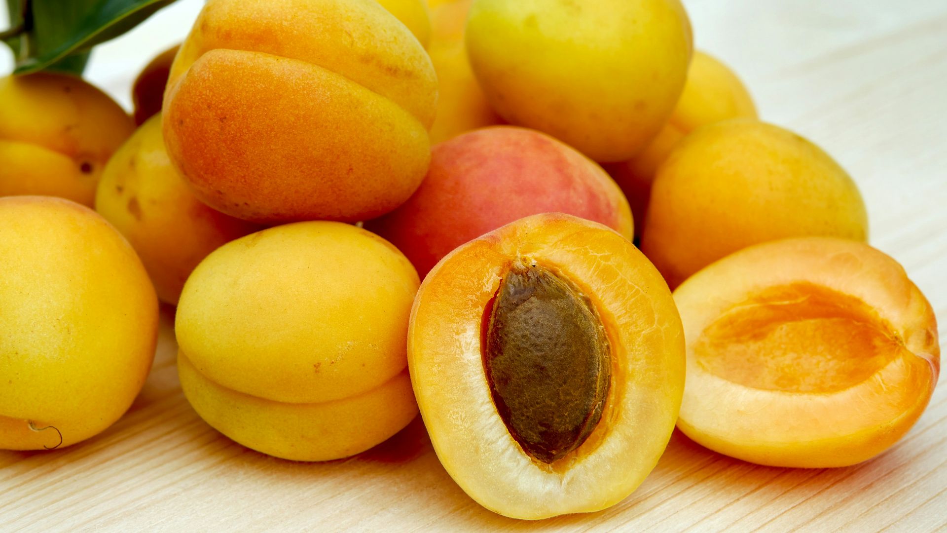 yellow round fruits on white table