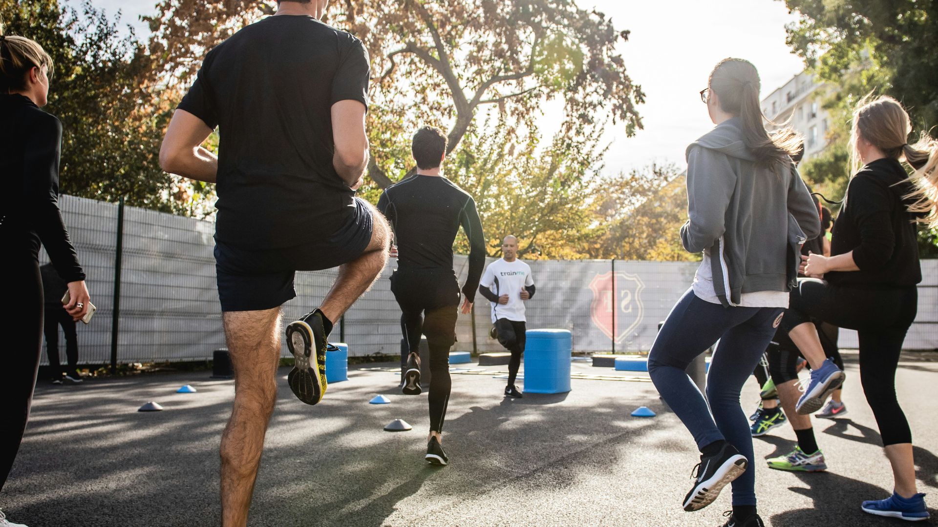 man in black t-shirt and black shorts running on road during daytime