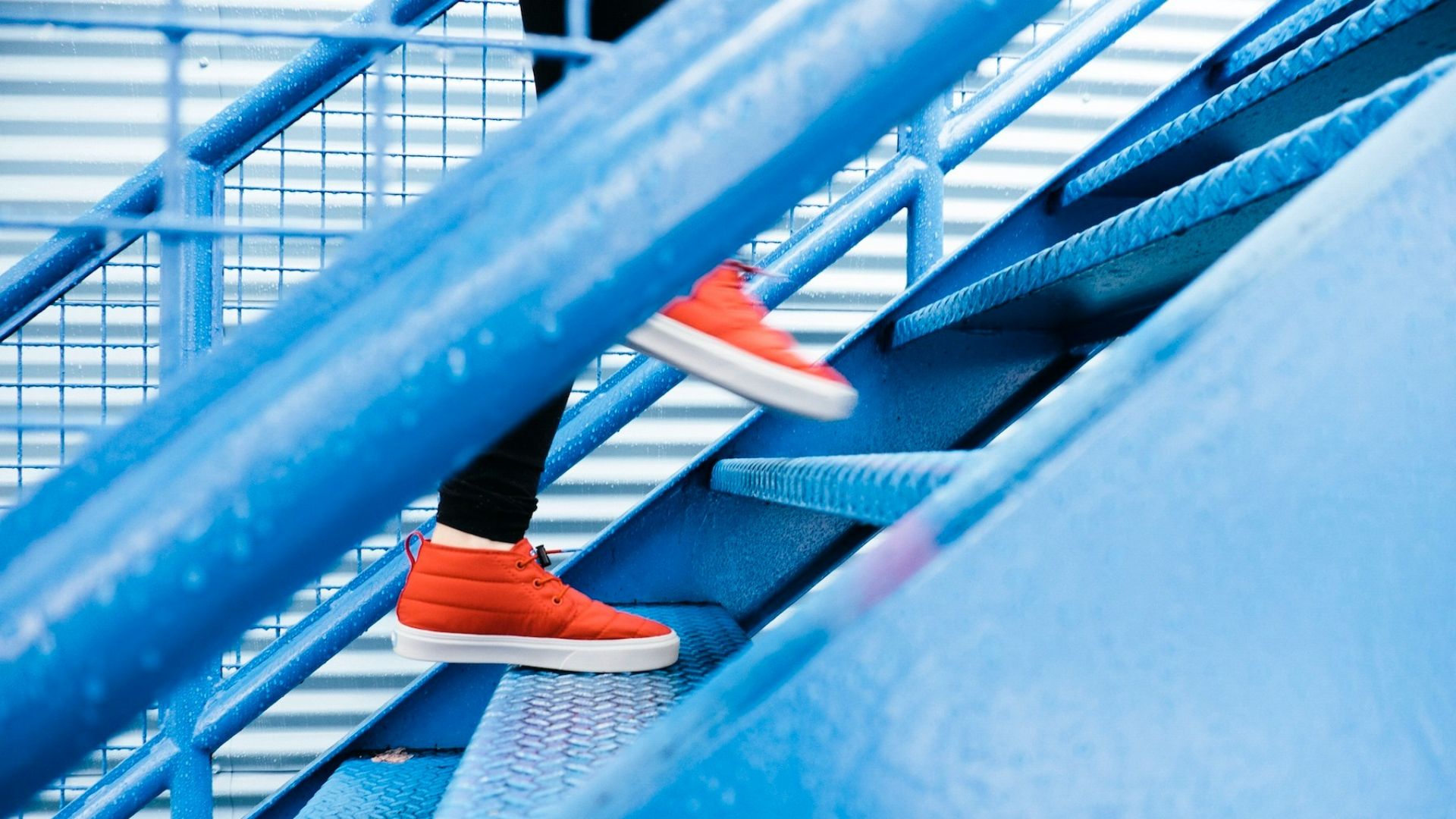 person stepping on blue stairs