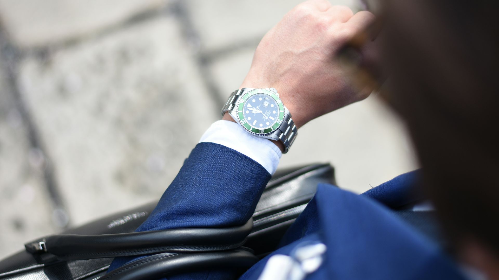 person looking at silver-colored analog watch