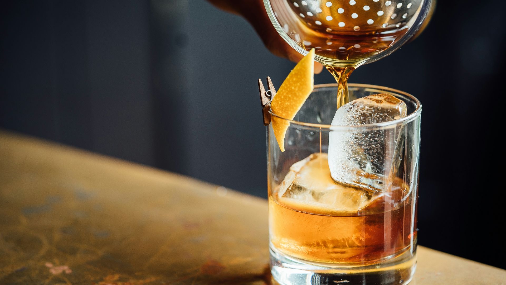 liquor pouring on clear shot glass